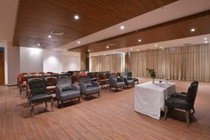 a conference room with chairs and a table in a room at Clubhouse Hotel Morbi in Morbi +13 photos