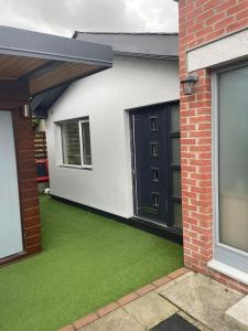 a house with a yard with green grass at Little Cottage Oassis in Dublin