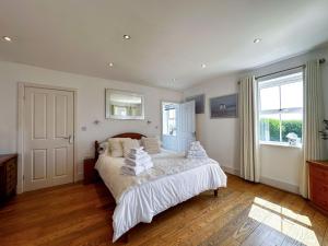 a bedroom with a bed and a large window at Sheerghlass in Castletown