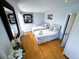 a living room with two white couches in it at Sheerghlass in Castletown