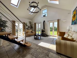 a living room with a couch and a chandelier at Sheerghlass in Castletown