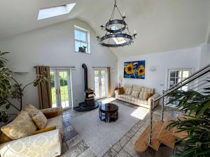 a living room with a couch and a chandelier at Sheerghlass in Castletown