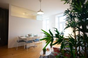 sala de estar con mesa, sillas y planta en Modern 3 Bedroom Apartment in City Center, en Viena