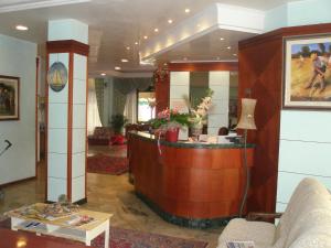 a lobby with a reception desk in a building at Hotel American in Lido di Jesolo