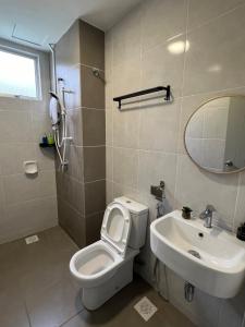 a bathroom with a toilet and a sink at MoonLight Sweet Homes 20pax karaoke in Kuala Selangor +31 photos