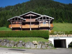 a large house with a large deck on a mountain at Appartement spacieux 6 personnes avec balcon à Châtel - FR-1-198-127 in Châtel