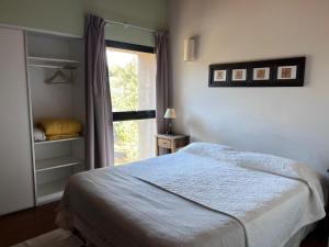 a bedroom with a large bed and a window at Costa de Lago - Cullelafquen in Villa Pehuenia +37 photos