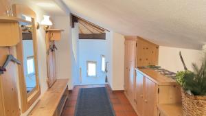 a hallway in a house with a kitchen with wooden cabinets at Ferienwohnung Vesna & Alex in Elmen