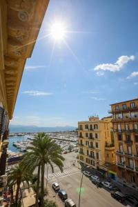a view of a city with palm trees and buildings at Lungomare Suite & Spa in Naples