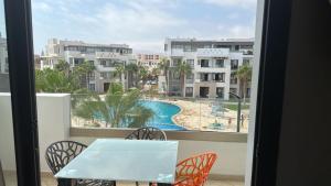 a balcony with a table and chairs and a view of a pool at La perle du sud in Agadir