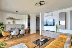 a living room with a couch and a table at Magic view - Apartment with Pool in Budva