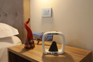 a alarm clock on a table in a bedroom at Lungomare Suite & Spa in Naples