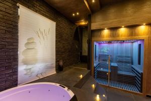 a bathroom with a tub and a brick wall at Lungomare Suite & Spa in Naples