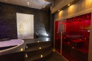 a bathroom with a bath tub and a red shower at Lungomare Suite & Spa in Naples