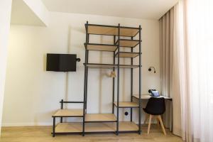 a black book shelf in a room with a television at The Gate Porto in Porto