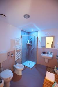 a bathroom with a shower and a toilet and a sink at Lungomare Suite & Spa in Naples