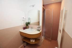 a bathroom with a sink and a shower at Lungomare Suite & Spa in Naples