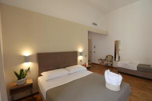 a bedroom with a large bed with white sheets at Lungomare Suite & Spa in Naples