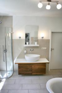 a white bathroom with a sink and a shower at Ferienhaus Drewitz (EOC-FUP 07/2017) in Drewitz