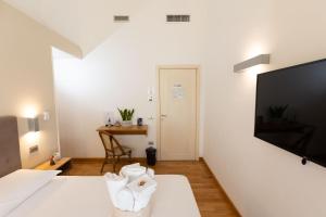 a hotel room with a bed with a flat screen tv at Lungomare Suite & Spa in Naples
