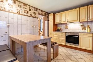 a kitchen with a wooden table in a room at Große Ferienwohnung mit Garten in Trollenhagen