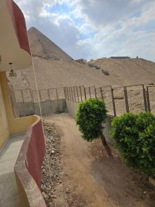 a fence with a view of the pyramid at The great pyramids view inn in Cairo
