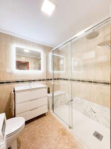 a bathroom with a shower and a toilet and a sink at Casa Rural Gandia in Bocairent