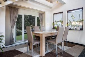 a dining room with a wooden table and chairs at Ferienwohnung über 2 Etagen in Trollenhagen