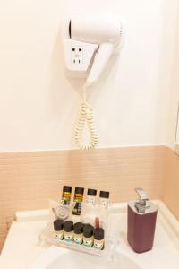 a bathroom sink with a blow dryer and bottles on it at Lungomare Suite & Spa in Naples