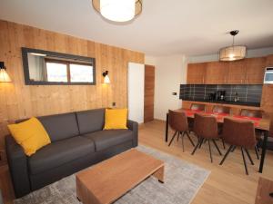 a living room with a couch and a table at Charmant appartement neuf avec balcon, 2 chambres, 2 SDB et parking au cœur des Saisies - FR-1-293-272 in Hauteluce