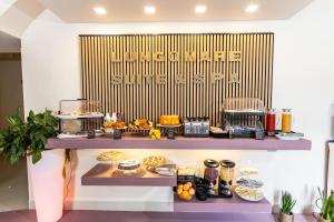 a bakery with a buffet of food on a shelf at Lungomare Suite & Spa in Naples