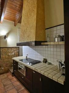a kitchen with a sink and a stove top oven at L'AMAGATALL DEL MONTNEGRE in Villalba Saserra