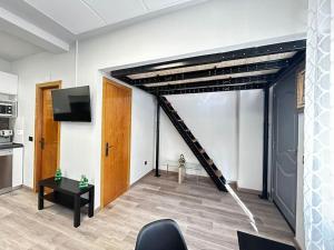 a living room with a staircase in a room at Apartamento amueblado en el centro de Madrid in Madrid