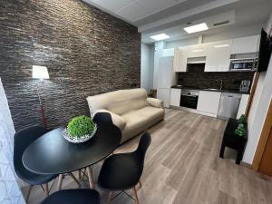 a living room with a couch and a table and chairs at Apartamento amueblado en el centro de Madrid in Madrid