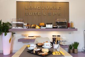 a table with a tray of food on it at Lungomare Suite & Spa in Naples