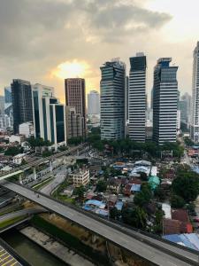 a city with a highway in front of tall buildings at Summer Suites Studio With Balcony Nearby KL City Centre in Kuala Lumpur +122 photos