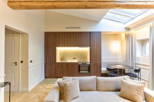 a living room with a couch and a table at Maison Iéna - Serviced Apartments on Champs Elysées in Paris