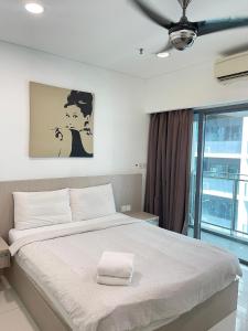 a bedroom with a large white bed with a ceiling at Summer Suites Studio With Balcony Nearby KL City Centre in Kuala Lumpur