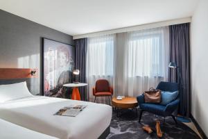 a hotel room with a bed and a chair at Mercure Amsterdam City Hotel in Amsterdam +151 photos
