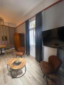 a living room with a coffee table and a tv at Villa Burgau, C&H in Monschau