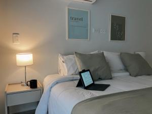 a laptop computer sitting on top of a bed at Alfa Suites en el casco histórico de Salta in Salta
