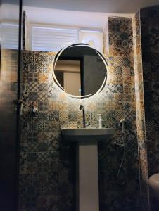 a bathroom with a sink and a mirror on the wall at Bharat Milap Home Stay in Varanasi