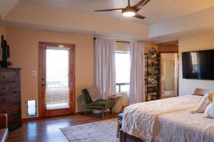 a bedroom with a bed and a chair and a window at Southwestern Desert Escape Pool, Hot, Tub, Sleeps 12 in Fountain Hills +27 photos