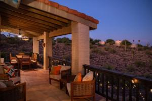 an outdoor patio with chairs and tables at night at Southwestern Desert Escape Pool, Hot, Tub, Sleeps 12 in Fountain Hills