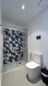 a bathroom with a toilet and a glass shower at Hotelito Boutique Badalona Gran Villa in Badalona