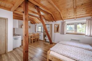 a bedroom with a bed and a dining room at Resort Vysoká Lípa in Jetřichovice +115 photos
