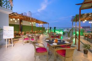 a restaurant with tables and chairs on a roof at HOTEL SKY VIEW - Zirakpur, Chandigarh in Zirakpur