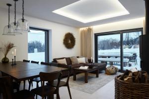 a living room with a table and a couch at Chalupa Nadohled in Červený Potok