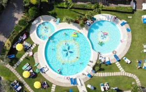 an overhead view of two pools at a resort at Majestic Palace in Malcesine +64 photos