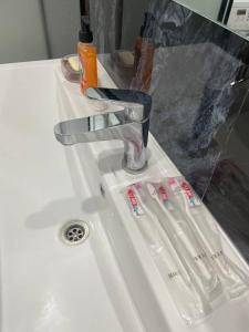 a bathroom sink with two toothbrushes on it at 3 bedroom apartment with 2 restroom in the Ala Park Business class in Almaty +11 photos